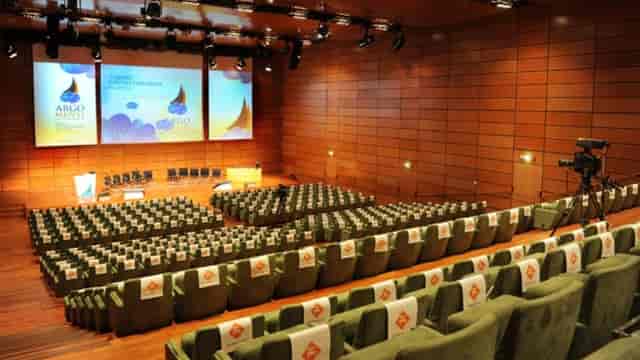Lingotto conference auditorium with stage, screens.