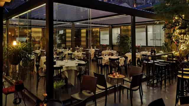 Outdoor cocktail reception venue, retractable roof, ambient lighting