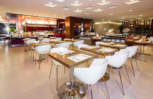 Modern Milan hotel restaurant, flexible seating, event buffet