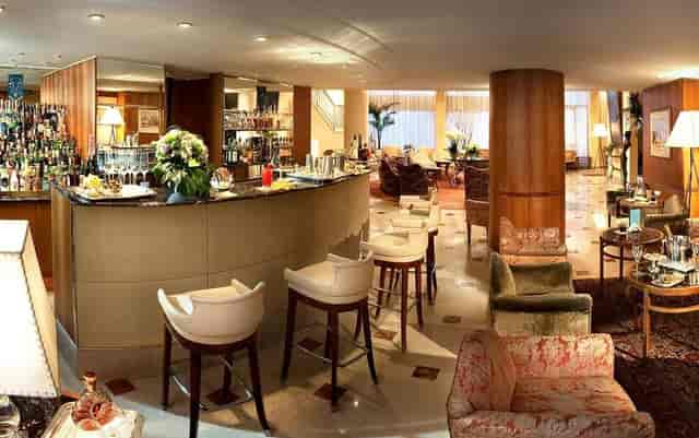 Elegant Milan hotel lounge bar, cocktail reception, networking event