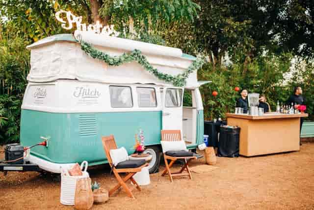 Vintage camper photo booth at event with bar