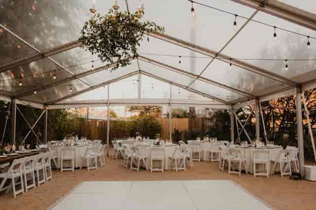 Ivy Hall outdoor wedding tent, elegant tables, string lights, event rental