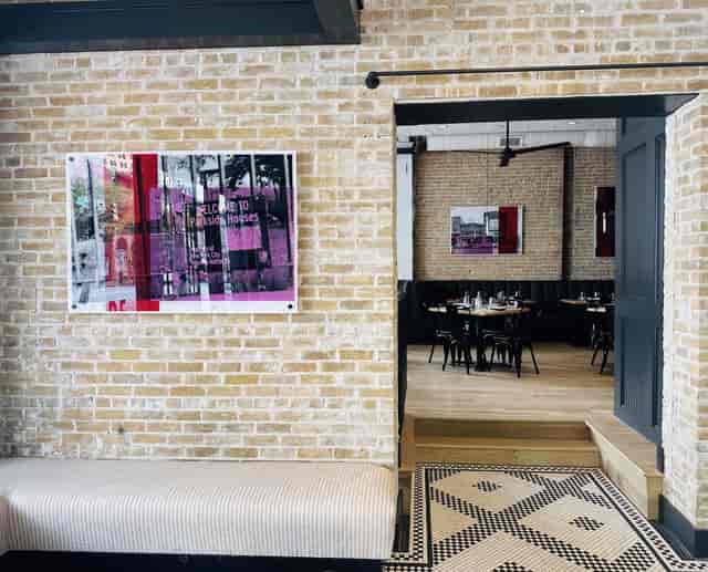 Chic bistro venue, exposed brick, modern art. Event space, party venue.