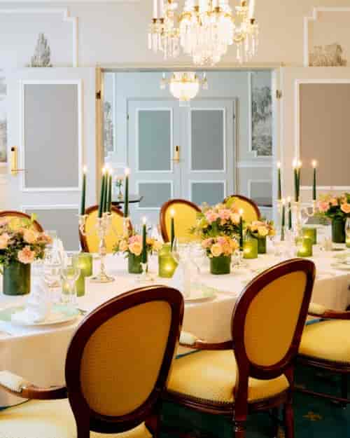 Elegant dining table setup with floral centerpieces for formal events at Hotel Bristol.