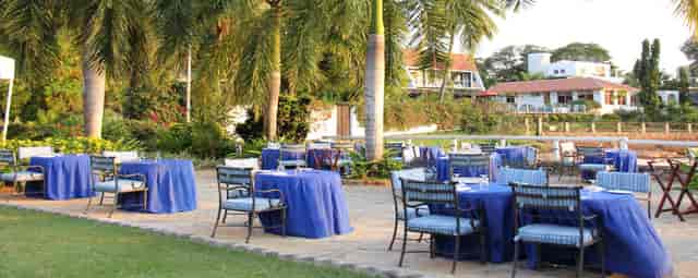 Outdoor banquet salon at Coral Beach Hotel Dar es Salaam with blue linens for incentive events.