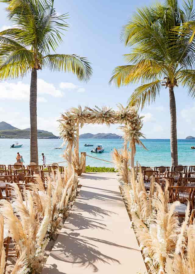 Beach wedding floral arch, intimate seating, destination event