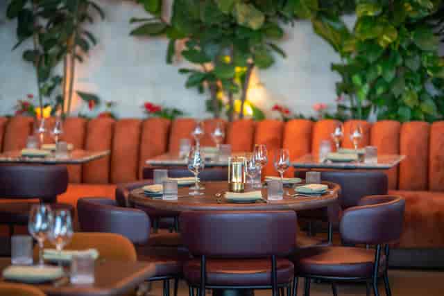 Edena Room at HERA Restaurant: cozy orange seating for upscale dinners and corporate events.