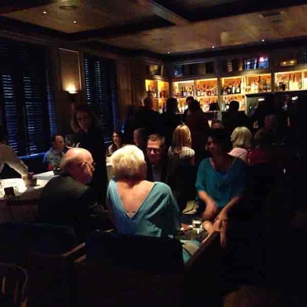 Austin cocktail reception: dim bar, seated guests