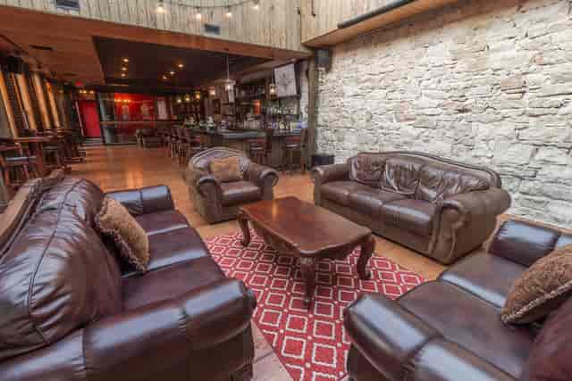Rustic bar event space, leather seating, stone walls, cocktail reception, private dinner