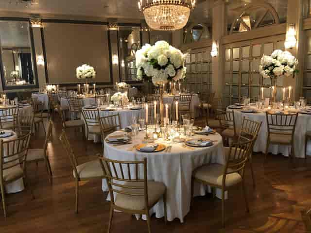 Elegant Austin Club gala with gold chairs, floral centerpieces, chandeliers