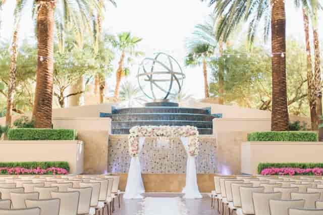 Vegas outdoor wedding arch, fountain backdrop, hotel ceremony