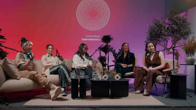 Panel discussion at Qube Elephant Lounge with vibrant decor and engaging speakers.