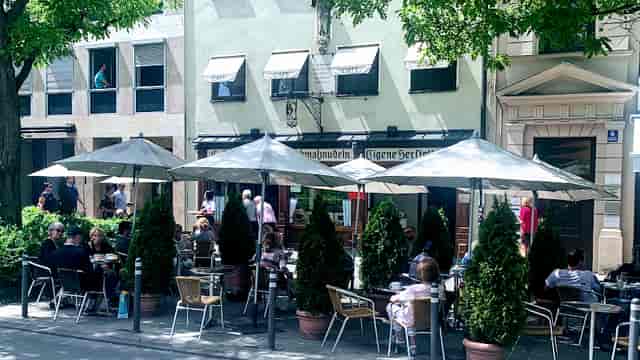 Viennese cafe networking event outdoor seating umbrellas