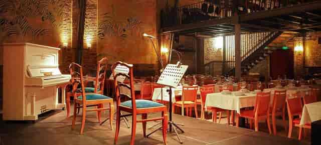 Kesselhaus venue: stage, piano, banquet tables - concert, dinner