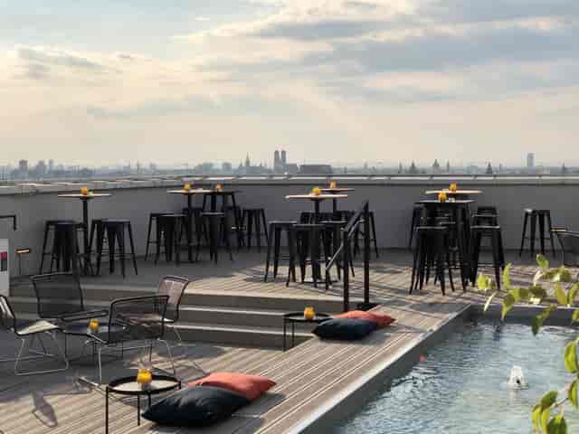 Rooftop bar terrace, city views, cocktail reception, networking event