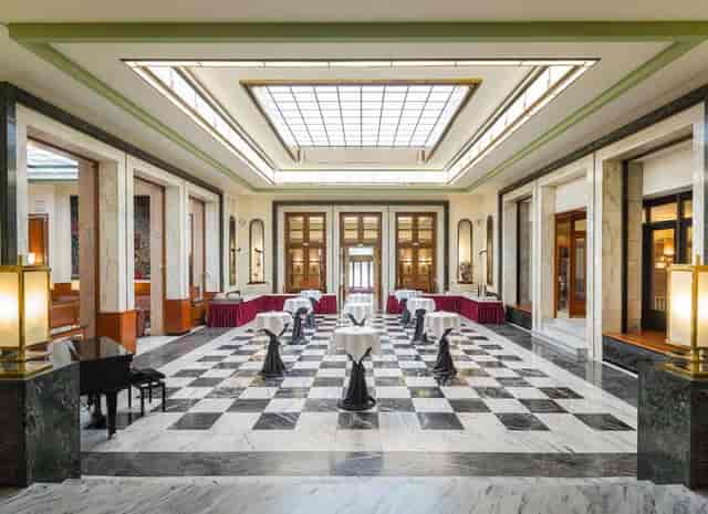 Elegant lounge event space, checkered floor, hotel reception, networking