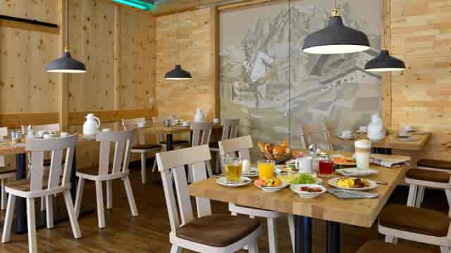 Rustic Zirbenstube hotel retreat, wood mountain mural, corporate event meeting