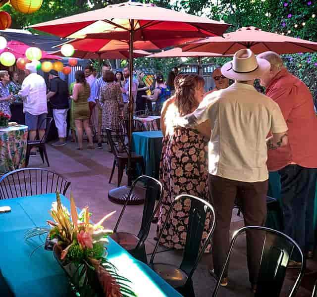 Outdoor networking reception at Café Frida Gallery with ambient lantern lighting.