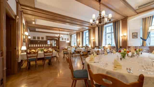 Elegant wood-paneled banquet hall at Romantik Hotel zur Post for corporate dining and events.