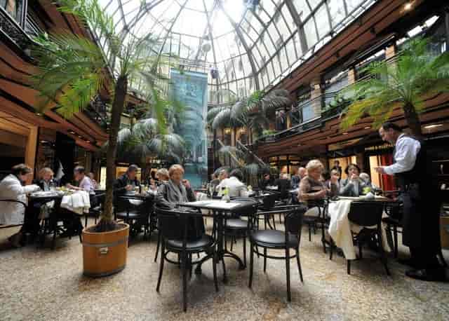 Cafe Luitpold atrium with tropical greenery for high-end networking lunch or VIP event.