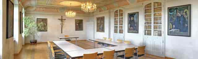 Nikolaussaal boardroom with ornate architecture and U-shape event setup for corporate meetings.