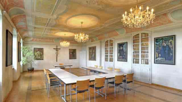 Historic Alter Pferdestall meeting space, U-shape setup for corporate events and workshops.