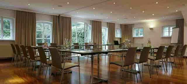 U-shape meeting room at LA VILLA featuring wooden floors for corporate events and board meetings.