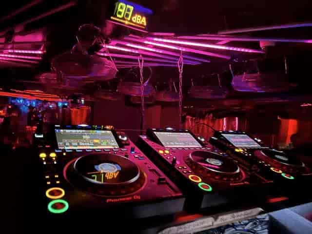 DJ booth at Palais Privat Club with moody lighting for evening receptions and brand activations.