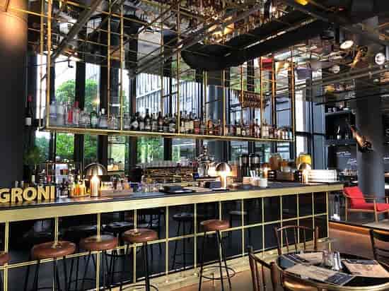 Industrial rooftop terrace bar with gold accents for upscale networking and corporate events.