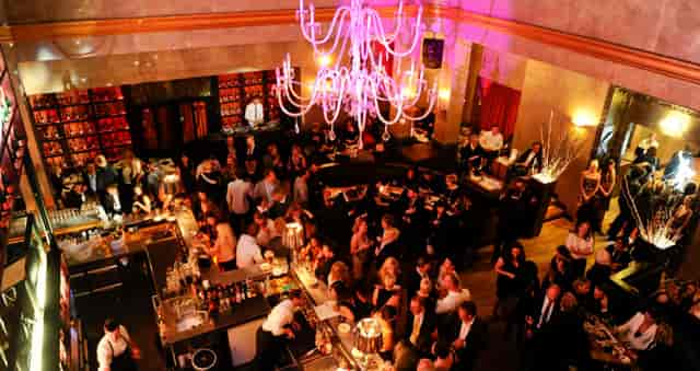 Münchner Stuben upscale corporate gala, bar and chandelier focal point for evening reception.