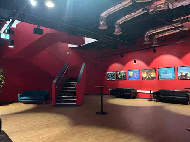 Stylish Riverside Studios event space with red backdrop, ideal for networking and gatherings.