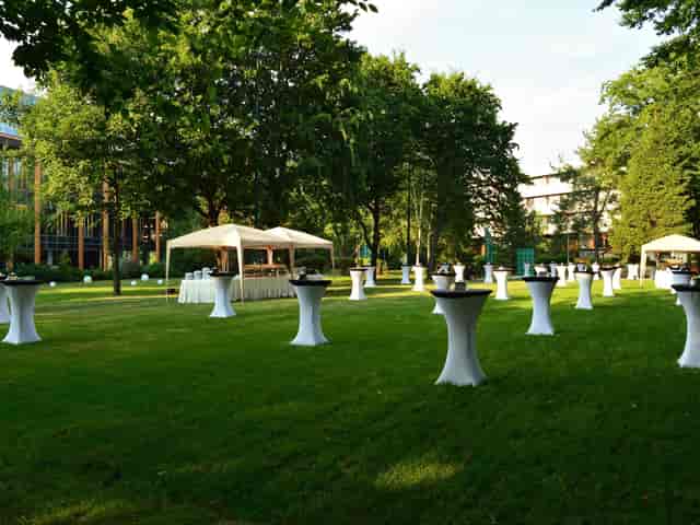 Outdoor reception setup at Pine Garden, Crowne Plaza Bucharest, ideal for networking events.