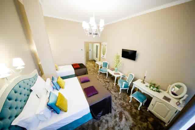 Salonul Alb at Grand Hotel Traian: classic triple-occupancy boutique hotel room for event lodging.