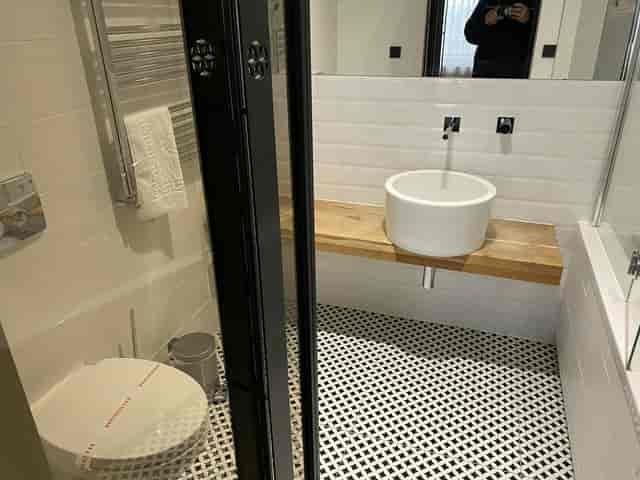 Modern hotel bathroom with vessel sink at CARO Urban Resort for event venue and luxury accommodation.
