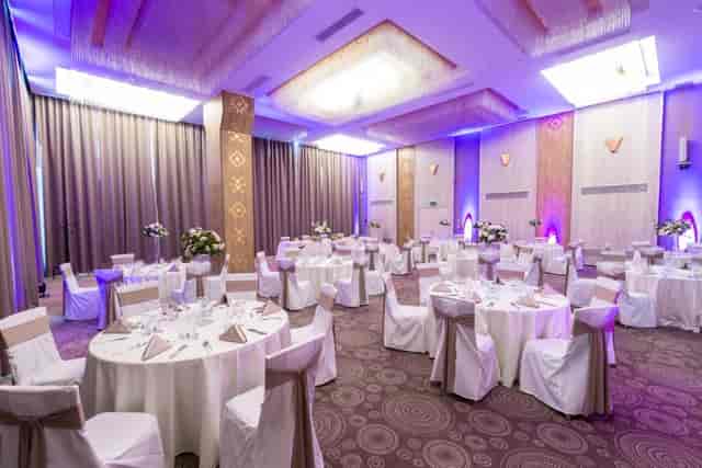 Banquet hall at Mezanin Unirea Hotel with purple uplighting for formal dinner and event venue.