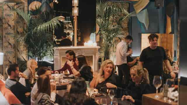 Intimate Balthazar garden venue with ambient candlelight for high-end networking and VIP dinners.