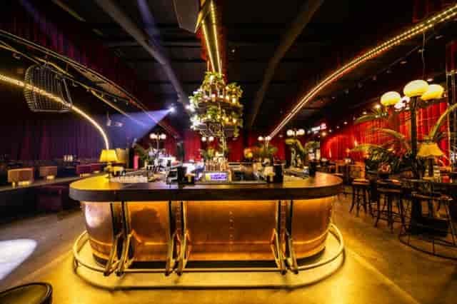 Fratelli Ristorante with velvet decor and central bar for upscale networking and evening soirées.