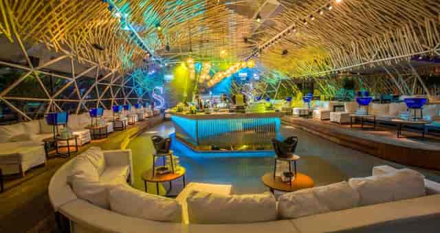 Tiered bamboo lounge at Fratelli: upscale networking event space with modern LED lighting.