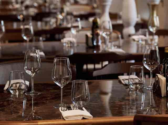Hanu' lui Manuc restaurant dining room with polished glassware for private business lunches.