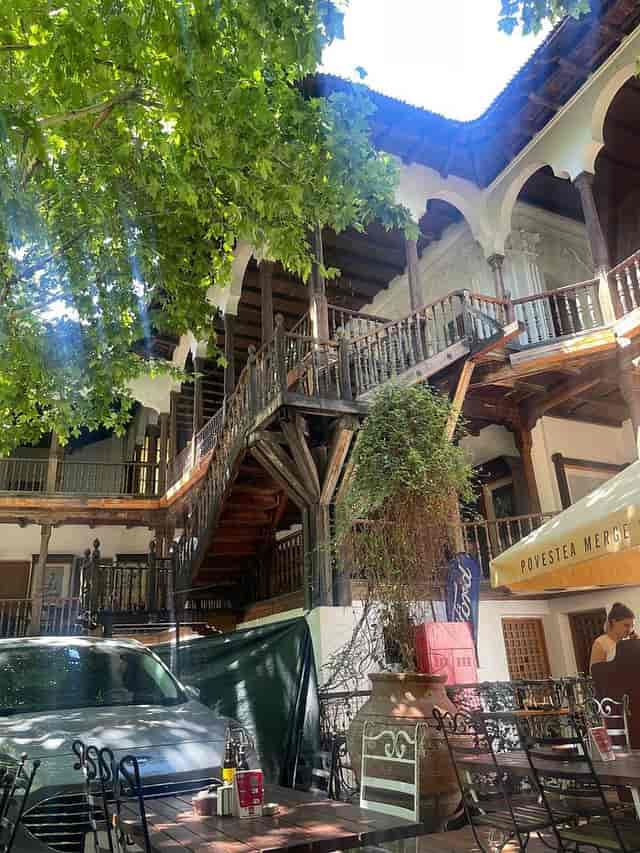 Rustic garden venue at Hanu' lui Manuc with parking encroachment, ideal for outdoor events.