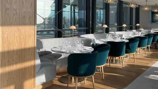 Upscale private dining room with tiered seating, ideal for corporate lunches and VIP dinners.