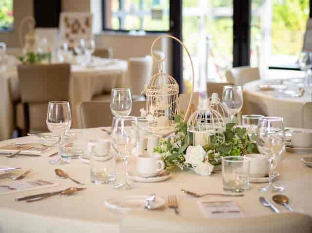 Vintage birdcage centerpiece wedding table setup at The Aviary event venue.