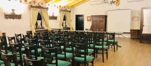 Theater-style conference room at Pensiunea Casa Pandora, rustic event venue, corporate meeting setup.