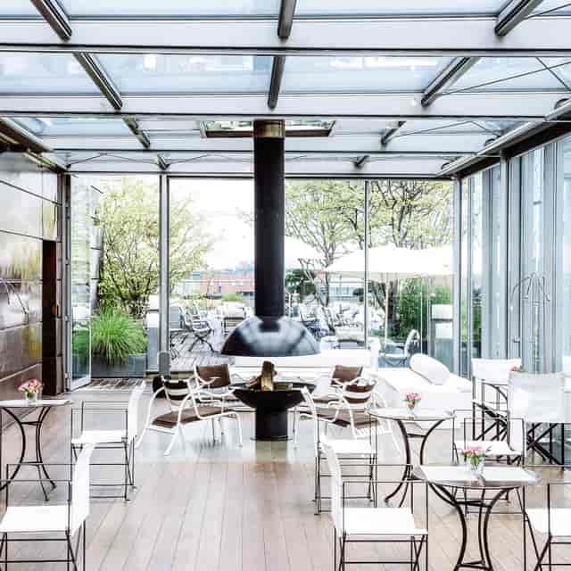 Winter garden with glass walls at Bayerischer Hof, perfect for upscale events and gatherings.