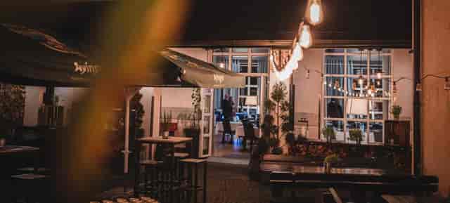 Charming outdoor venue at Wirtsgarten, perfect for events with warm lighting and greenery.