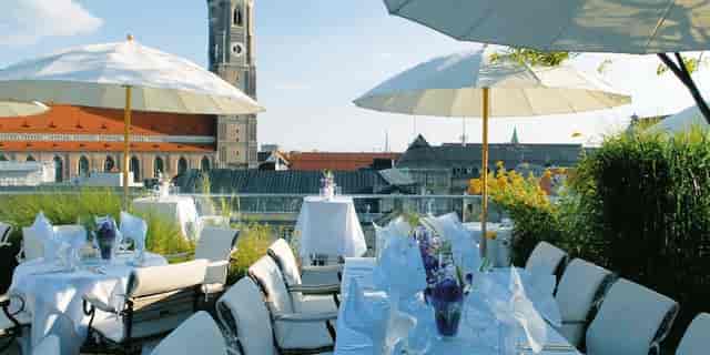 Elegant rooftop venue with floral centerpieces, ideal for weddings and corporate events.