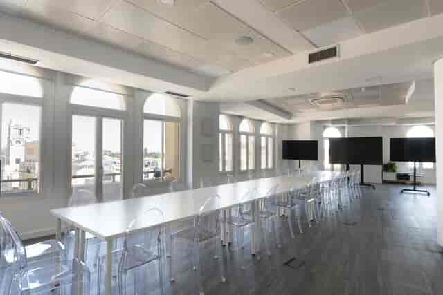Boardroom at Loop 21 with ghost chairs for hybrid meetings and collaborative workshops.