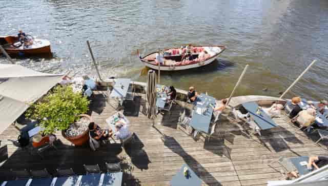 Vessel outdoor waterfront terrace with modular seating for corporate networking and upscale events.