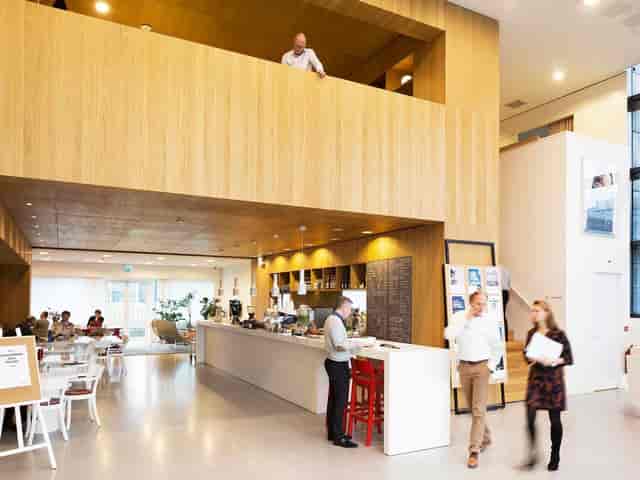 Modern breakout area with coffee station for hybrid networking and conference events.