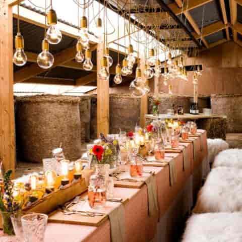 Rustic-chic Brasserie Stuyvesant event space with hay bale seating and Edison bulb lighting.
